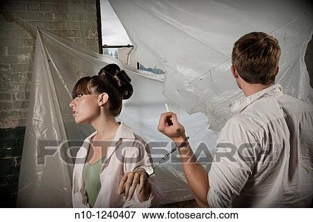 Young couple handcuffed together View Large Photo Image Stock Photo - Young couple handcuffed together. Fotosearch
