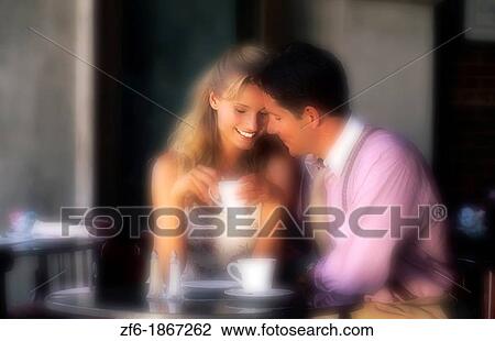 Young couple having affectionate talk in cafe View Large Photo Image Stock Image - Young couple having affectionate talk in cafe. Fotosearch