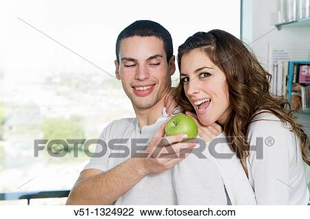 Young couple having breaksfast in the kitchen in the morning View Large Photo Image Stock Image - Young couple having breaksfast in the kitchen in the morning. Fotosearch
