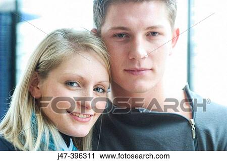 Young couple, headshot, smiling into camera View Large Photo Image Stock Image - Young couple, headshot, smiling into camera. Fotosearch