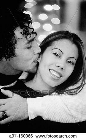 Stock Photograph - Young couple hugging. Fotosearch