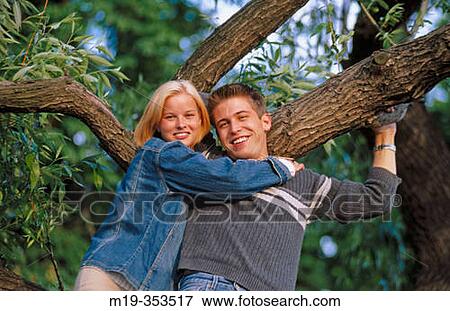 young couple in a tree View Large Photo Image Stock Photo - young couple in a tree. Fotosearch