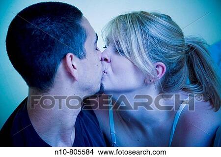 Young couple in bed together. View Large Photo Image Picture - Young couple in bed together.. Fotosearch