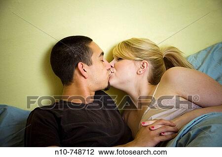 Young couple in bed together. View Large Photo Image Stock Image - Young couple in bed together.. Fotosearch