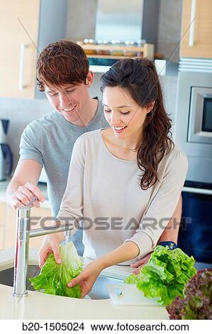 Young couple in kitchen View Large Photo Image Picture - Young couple in kitchen. Fotosearch
