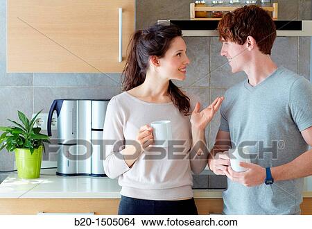 Young couple in kitchen View Large Photo Image Picture - Young couple in kitchen. Fotosearch