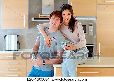 Young couple in kitchen View Large Photo Image Picture - Young couple in kitchen. Fotosearch