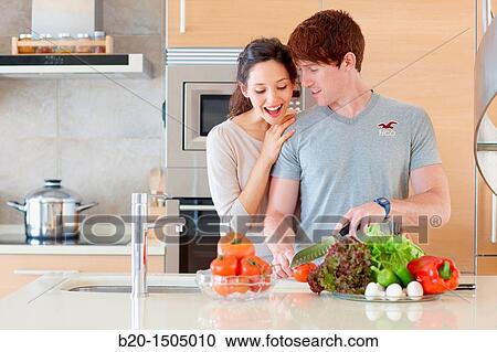 Young couple in kitchen View Large Photo Image Stock Image - Young couple in kitchen. Fotosearch