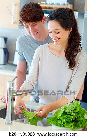 Young couple in kitchen View Large Photo Image Stock Image - Young couple in kitchen. Fotosearch
