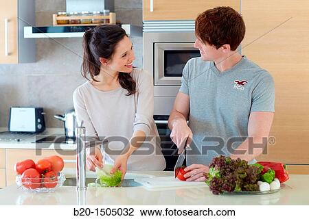 Young couple in kitchen View Large Photo Image Stock Image - Young couple in kitchen. Fotosearch