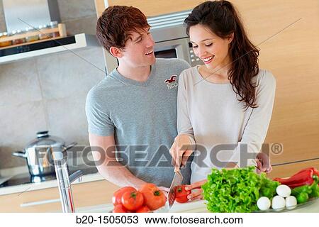 Young couple in kitchen View Large Photo Image Stock Image - Young couple in kitchen. Fotosearch