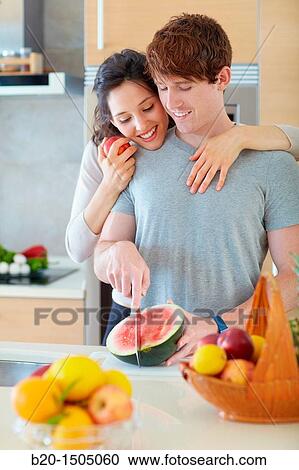 Young couple in kitchen View Large Photo Image Stock Image - Young couple in kitchen. Fotosearch