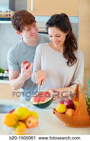 Young couple in kitchen View Large Photo Image Stock Image - Young couple in kitchen. Fotosearch