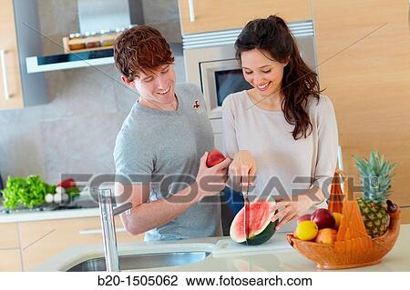 Young couple in kitchen View Large Photo Image Stock Image - Young couple in kitchen. Fotosearch