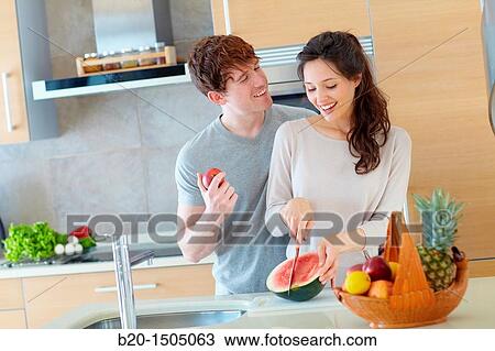 Young couple in kitchen View Large Photo Image Stock Image - Young couple in kitchen. Fotosearch