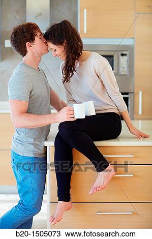 Young couple in kitchen View Large Photo Image Stock Image - Young couple in kitchen. Fotosearch