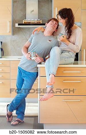 Young couple in kitchen View Large Photo Image Stock Image - Young couple in kitchen. Fotosearch
