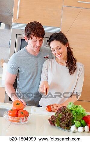Young couple in kitchen View Large Photo Image Stock Photo - Young couple in kitchen. Fotosearch