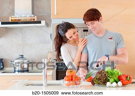 Young couple in kitchen View Large Photo Image Stock Photo - Young couple in kitchen. Fotosearch