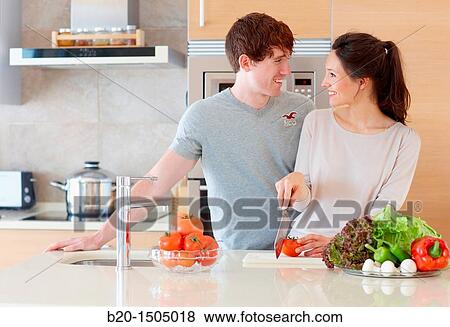 Young couple in kitchen View Large Photo Image Stock Photo - Young couple in kitchen. Fotosearch