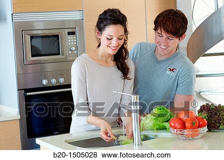 Young couple in kitchen View Large Photo Image Stock Photo - Young couple in kitchen. Fotosearch