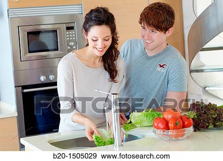 Young couple in kitchen View Large Photo Image Stock Photo - Young couple in kitchen. Fotosearch