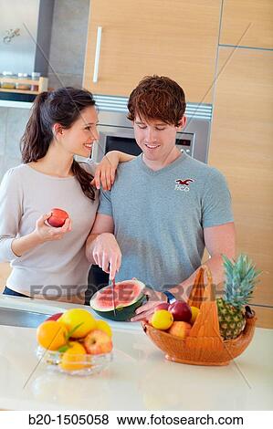 Young couple in kitchen View Large Photo Image Stock Photo - Young couple in kitchen. Fotosearch