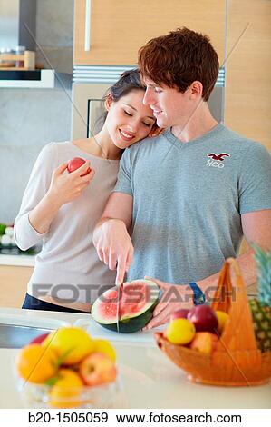 Young couple in kitchen View Large Photo Image Stock Photo - Young couple in kitchen. Fotosearch