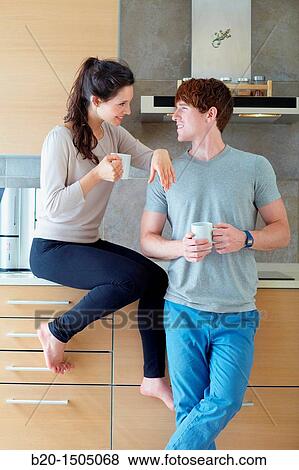 Young couple in kitchen View Large Photo Image Stock Photo - Young couple in kitchen. Fotosearch