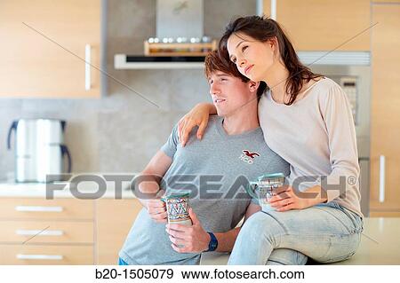 Young couple in kitchen View Large Photo Image Stock Photo - Young couple in kitchen. Fotosearch