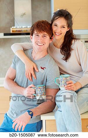 Young couple in kitchen View Large Photo Image Stock Photo - Young couple in kitchen. Fotosearch