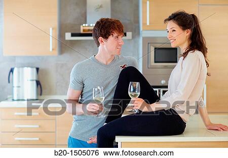 Stock Photograph - Young couple in kitchen. Fotosearch