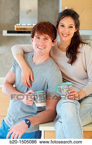Young couple in kitchen View Large Photo Image Stock Photograph - Young couple in kitchen. Fotosearch
