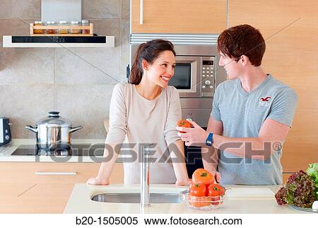 Stock Photography - Young couple in kitchen. Fotosearch