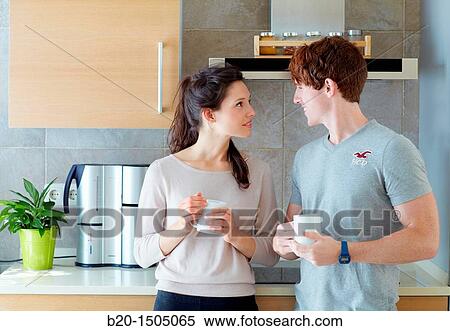 Stock Photography - Young couple in kitchen. Fotosearch