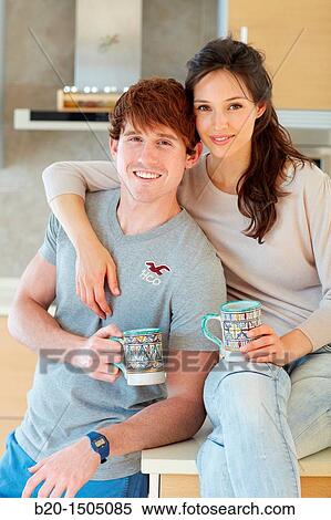 Young couple in kitchen View Large Photo Image Stock Photography - Young couple in kitchen. Fotosearch