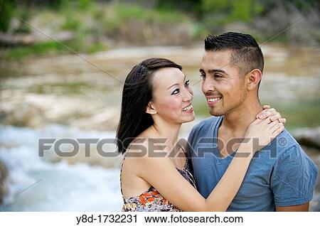 Young couple in love - man, 22, hispanic, woman, 20, korean, location natural environment near Leakey, Texas, USA View Large Photo Image Stock Image - Young couple in love - man, 22, hispanic, woman, 20, korean, location natural environment near Leakey, Texas, USA. Fotosearch