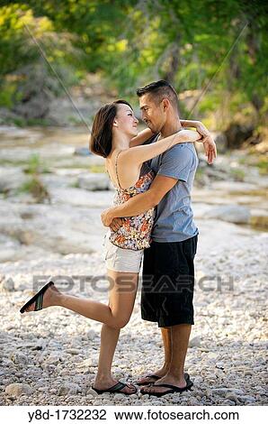 Young couple in love - man, 22, hispanic, woman, 20, korean, location natural environment near Leakey, Texas, USA View Large Photo Image Stock Image - Young couple in love - man, 22, hispanic, woman, 20, korean, location natural environment near Leakey, Texas, USA. Fotosearch
