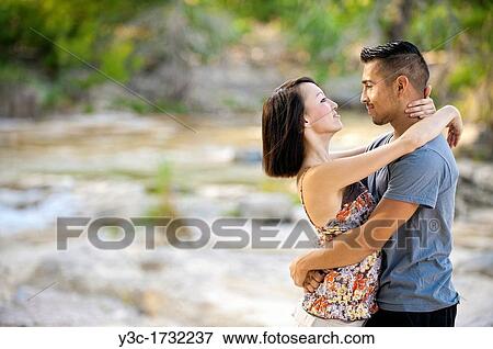 Young couple in love - man, 22, hispanic, woman, 20, korean, location natural environment near Leakey, Texas, USA View Large Photo Image Stock Photo - Young couple in love - man, 22, hispanic, woman, 20, korean, location natural environment near Leakey, Texas, USA. Fotosearch