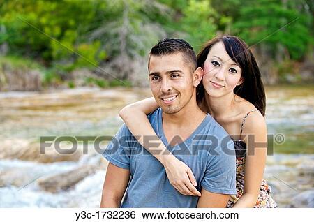 Young couple in love - man, 22, hispanic, woman, 20, korean, location natural environment near Leakey, Texas, USA View Large Photo Image Stock Photograph - Young couple in love - man, 22, hispanic, woman, 20, korean, location natural environment near Leakey, Texas, USA. Fotosearch