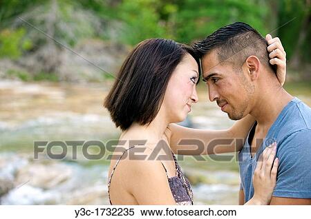 Young couple in love - man, 22, hispanic, woman, 20, korean, location natural environment near Leakey, Texas, USA View Large Photo Image Stock Photography - Young couple in love - man, 22, hispanic, woman, 20, korean, location natural environment near Leakey, Texas, USA. Fotosearch