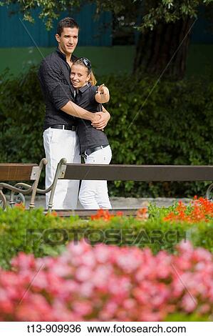 Stock Photograph - Young couple in park, she is pointing with finger. Fotosearch