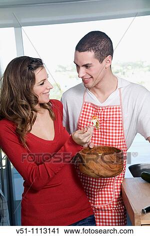 Young couple in the kitchen View Large Photo Image Stock Image - Young couple in the kitchen. Fotosearch