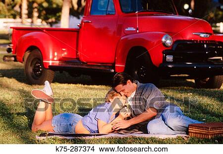 Young couple in the park View Large Photo Image Picture - Young couple in the park. Fotosearch