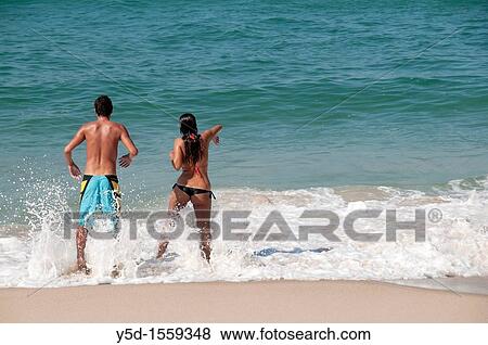 young couple in the water of Atlantic ocean, beach in Foz do Arelho, Slver Coast, Leiria district, Portugal, middle of October View Large Photo Image Stock Photo - young couple in the water of Atlantic ocean, beach in Foz do Arelho, Slver Coast, Leiria district, Portugal, middle of October. Fotosearch