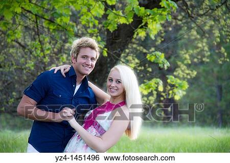 young couple in the woods durring engagement shoot View Large Photo Image Stock Photograph - young couple in the woods durring engagement shoot. Fotosearch
