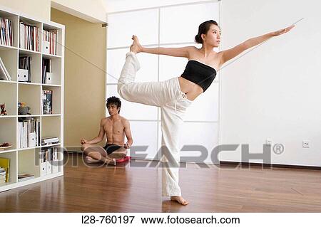 Young couple in yoga attitude, indoors View Large Photo Image Stock Photo - Young couple in yoga attitude, indoors. Fotosearch