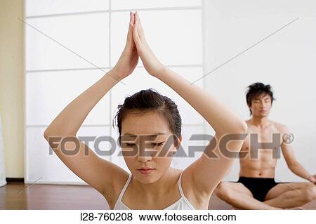 Young couple in yoga attitude, indoors View Large Photo Image Stock Photo - Young couple in yoga attitude, indoors. Fotosearch