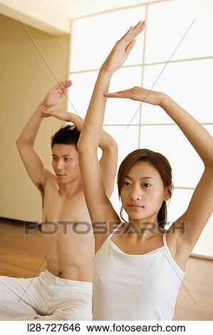 Young couple in yoga attitude, indoors View Large Photo Image Stock Photograph - Young couple in yoga attitude, indoors. Fotosearch