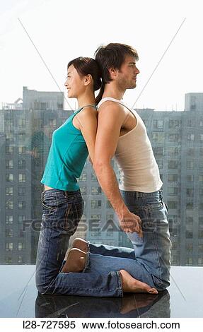 Young couple in yoga attitude indoors View Large Photo Image Stock Photography - Young couple in yoga attitude indoors. Fotosearch